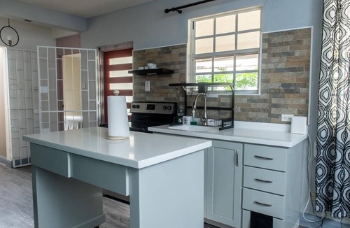 Harrismith House | Relaxing 3-bedroom home with flex-space AC and charming roof deck ocean view